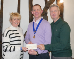 Immediate Past-President, Martin Stibbards, presents a cheque to Chris and Lisa Green
